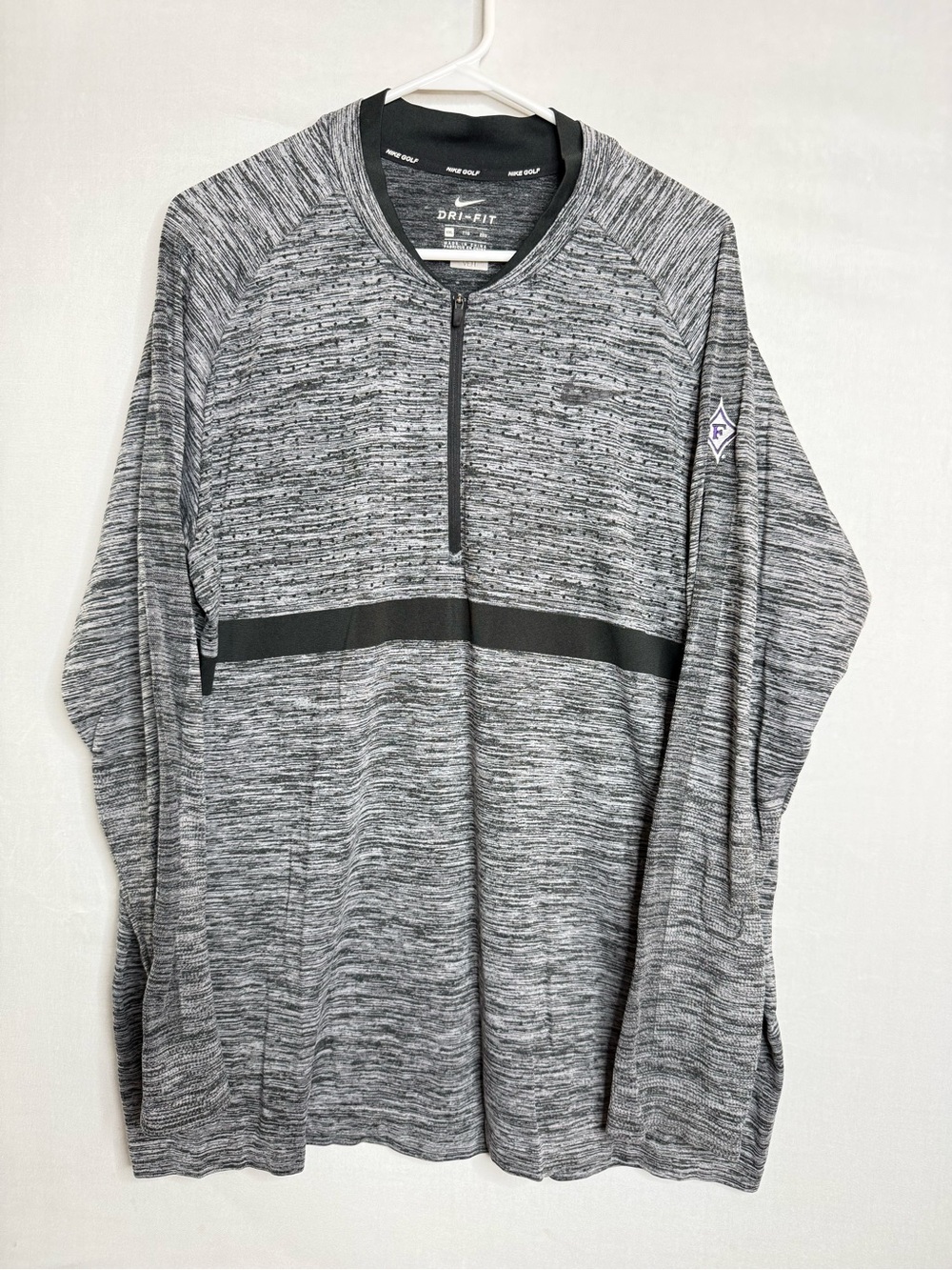 gray and black Nike Golf Dri-FIT 1/4-zip long-sleeve performance pullover featur